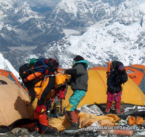 Sherpas loading gear on South Col